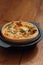 Tomato and spring onion quiche in a cast iron pot dish