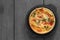 Tomato and spring onion quiche in a cast iron pot dish on wood