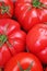 Tomato texture. Fresh big red tomatoes closeup background photo. Pile of tomatoes. Tomato pattern with studio lights.