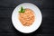 Tomato vegetarian spahgetti with cheese parmesan and basilic on