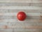 Tomato on a wooden surface. Fresh tomato on a cutting board. Tomato for salads, soups, pizza and ketchup.