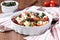 Tomatoes baked with cheese feta, smoked sausages, herbs, olives