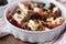 Tomatoes baked with cheese feta, smoked sausages, herbs, olives