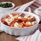 Tomatoes baked with cheese feta, smoked sausages, herbs, olives, Mediterranean dish