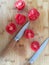 Tomatoes on the bamboo board with knives