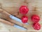 Tomatoes on the bamboo board with knives