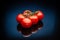 Tomatoes on a black mirror background in the splash of water