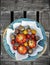 Tomatoes in blue basket with white napkin