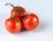 Tomatoes on a branch. Three ripe tomatoes on a branch.