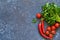 Tomatoes, chilli and parsley on a concrete, kitchen table. View from above