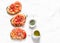 Tomatoes, cream cheese, oregano bruschetta on a light background, top view. Delicious appetizers, tapas, snack.