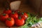 Tomatoes, dill, parsley, garlic on a wooden table