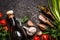 Tomatoes, green onions, salt, spices for cooking on a dark background