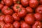 .Tomatoes lying on a pile on top of each other, tomato texture. Selective focus