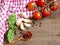 Tomatoes, mint, garlic and pepper on dark wood and dish towel