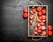 Tomatoes with old hatchet on the tray.