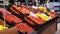 Tomatoes and other fresh vegetables with price tags on supermarket shelves