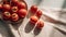 Tomatoes in a plate on a white tablecloth. Top view.