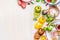 Tomatoes salad preparation. Tomatoes cooking ingredients on white marble cutting board. Various Colorful sliced tomatoes on white