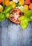 Tomatoes slices with basil leaves on rustic background