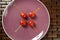 Tomatoes snack in a purple dish and colored sticks