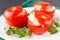 Tomatoes stuffed with spinach, cheese and herbs, close up. Delicious and nutritious vegetarian meal