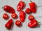 Tomatoes and sweet peppers on gray tablecloth. Top view