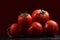 Tomatoes under water drops, red background