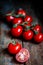 Tomatoes on the vine on rustic wooden background