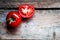 Tomatoes on the vine on rustic wooden background