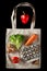 Tomatoes, walnuts, quail eggs, lettuce and bell pepper on eco friendly canvas bag