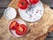 Tomatoes on a wooden cut, kitchen stand with a snowman pattern, a scattering of peppers.