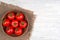 Tomatoes on wooden table in bowl top view