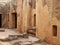 Tomb doors and niches in a carved sandstone wall forming a street like view in the temple of the kings area in paphos cyprus