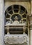 Tomb with latin inscription and skulls on top inside the Genoa Cathedral