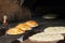 Tombik buns and Turkish Ramazan Pide bread before baking. Bread prepared for baking is in front of the stove. Morning pastries.