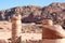Tombs digged in red rock mountain and old columns of wonderful Petra. Jordan
