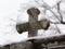 Tombstone cross covered with snow