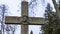 Tombstone in the form of a cross with bas-relief of the head of Jesus