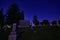 tombstones and a burial vault reflects moonlight on a dark night in city cemetery in Wisconsin