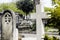 Tombstones in cemetery at dusk, gothic style crosses