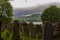 Tombstones in cemetery with flying bird and lake in background