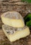 Tomme cheese of Savoie placed on a piece of wood