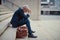 Tomorrow will be a better day. a dejected businessman sitting on the stairs outside his office with his head in his