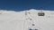 Tonale, Ponte di Legno, Italy. Chairlift with skiers moving to the top of the ski run in a wonderful sunny day