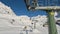 Tonale, Ponte di Legno, Italy. Time lapse chairlift with skiers moving to the top of the mountain in a wonderful sunny day