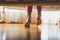 Toned closeup image of young barefoot girl in pajamas standing on wooden floor in bedroom