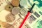 Toned illustrative editorial of Japanese Yen in notes and coins and a miniature katana in red scabbard