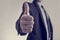 Toned image of businessman showing a thumbs up sign towards you