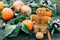 Toned image Christmas composition with snowy Tangerines gingerbread man, Pine cones, Walnuts on Wooden Background, holiday